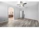 Spacious bedroom with wood-look tile flooring and ceiling fan at 1270 E Marcella Ln, Gilbert, AZ 85295