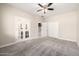 Bedroom with carpet flooring, ceiling fan and access to bathroom at 1270 E Marcella Ln, Gilbert, AZ 85295