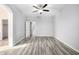 Bright bedroom featuring wood-look tile floors and a ceiling fan at 1270 E Marcella Ln, Gilbert, AZ 85295