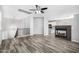 Open living room with modern fireplace and kitchen view at 1270 E Marcella Ln, Gilbert, AZ 85295