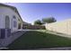 Landscaped backyard with artificial turf and a wall at 1374 E Kingman Pl, Casa Grande, AZ 85122