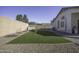 Artificial turf backyard with a block wall and storage shed at 1374 E Kingman Pl, Casa Grande, AZ 85122