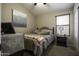 Well-lit bedroom with a queen-size bed and nightstand at 1374 E Kingman Pl, Casa Grande, AZ 85122