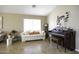 Bright living room featuring comfortable seating and a piano at 1374 E Kingman Pl, Casa Grande, AZ 85122