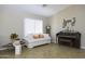 Bright living room featuring comfortable seating and a piano at 1374 E Kingman Pl, Casa Grande, AZ 85122