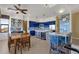 Modern kitchen with blue cabinets, an island, and a dining area at 15418 N Castillo Dr, Fountain Hills, AZ 85268