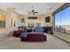 Spacious living room with two burgundy couches and a stunning view at 15418 N Castillo Dr, Fountain Hills, AZ 85268