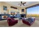 Spacious living room with fireplace, large windows, and mountain views at 15418 N Castillo Dr, Fountain Hills, AZ 85268