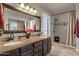 Double vanity bathroom with granite countertop and walk-in shower at 160 W La Vieve Ln, Tempe, AZ 85284