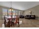 Formal dining room with a wooden table and chairs, and large windows at 160 W La Vieve Ln, Tempe, AZ 85284