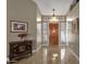 Bright entryway with tiled floor, wooden door, and decorative chest at 160 W La Vieve Ln, Tempe, AZ 85284