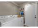 Laundry room with washer, dryer, and shelving at 160 W La Vieve Ln, Tempe, AZ 85284