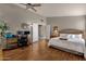 Main bedroom with wood floors, ceiling fan, and built-in workspace at 160 W La Vieve Ln, Tempe, AZ 85284