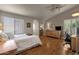 Spacious main bedroom with wood floors, a ceiling fan, and a workspace at 160 W La Vieve Ln, Tempe, AZ 85284