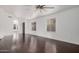 Bright living room featuring hardwood floors and a ceiling fan at 16019 S 40Th Way, Phoenix, AZ 85048