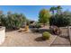 Landscaped backyard with desert plants, gravel, and a covered patio at 19941 N Summer Dream Dr, Surprise, AZ 85374