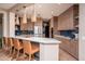 Modern kitchen with wood cabinets, white countertops and an open floor plan at 19941 N Summer Dream Dr, Surprise, AZ 85374