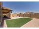 Artificial turf, fire pit, and covered patio at 20138 W Madison St, Buckeye, AZ 85326