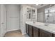 Double vanity bathroom with a large mirror and shower at 20138 W Madison St, Buckeye, AZ 85326