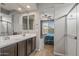 Bathroom with double vanity, shower, and bedroom view at 20138 W Madison St, Buckeye, AZ 85326