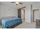 Primary bedroom with barn door to en-suite bathroom and a ceiling fan at 20138 W Madison St, Buckeye, AZ 85326