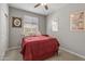 Cozy bedroom with a red comforter and window at 20138 W Madison St, Buckeye, AZ 85326