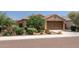 Single-story house with well-manicured landscaping and attached garage at 20138 W Madison St, Buckeye, AZ 85326