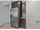 Stainless steel refrigerator with dark wood cabinetry and granite countertops at 20138 W Madison St, Buckeye, AZ 85326