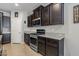 Modern kitchen features dark cabinetry, granite countertops, and stainless steel appliances at 20138 W Madison St, Buckeye, AZ 85326