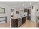 Kitchen island with granite countertop and stainless steel dishwasher at 20138 W Madison St, Buckeye, AZ 85326