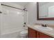 Bathroom with tub shower combo and wood vanity at 2028 N 77Th Ln, Phoenix, AZ 85035