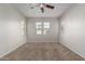 Spacious bedroom featuring three windows and a ceiling fan at 2028 N 77Th Ln, Phoenix, AZ 85035