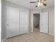 Bedroom with double door closet and access to stairs at 2028 N 77Th Ln, Phoenix, AZ 85035