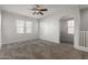 Bright bedroom with ceiling fan and neutral carpeting at 2028 N 77Th Ln, Phoenix, AZ 85035