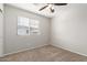 Simple bedroom with carpeted floor and ceiling fan at 2028 N 77Th Ln, Phoenix, AZ 85035