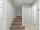 Carpeted staircase with coat hooks and tile flooring at 2028 N 77Th Ln, Phoenix, AZ 85035