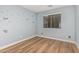 bedroom with light blue walls and wood floors at 20475 N Herbert Ave, Maricopa, AZ 85138