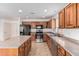 Kitchen with wood cabinets, granite countertops, and stainless steel appliances at 20475 N Herbert Ave, Maricopa, AZ 85138