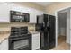 Kitchen features black appliances and granite countertops at 2150 W Alameda Rd # 1251, Phoenix, AZ 85085