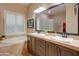 Elegant bathroom with double sinks, soaking tub, and a walk-in shower at 21556 S 215Th Pl, Queen Creek, AZ 85142