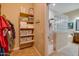 Bathroom with a walk-in shower, closet, and linen shelving at 21556 S 215Th Pl, Queen Creek, AZ 85142