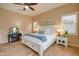 Well-lit bedroom with a king bed, nightstands and calm decor at 21556 S 215Th Pl, Queen Creek, AZ 85142