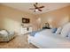 King-size bed, window seating, and lots of natural light in this bedroom at 21556 S 215Th Pl, Queen Creek, AZ 85142