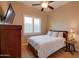 Bedroom with a double bed, TV, and plantation shutters at 21556 S 215Th Pl, Queen Creek, AZ 85142