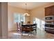 Round dining table with wooden chairs in a bright area at 21556 S 215Th Pl, Queen Creek, AZ 85142