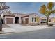 Single-story home with two-car garage and desert landscaping at 21556 S 215Th Pl, Queen Creek, AZ 85142