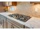 Gas cooktop and granite countertop in the kitchen at 21556 S 215Th Pl, Queen Creek, AZ 85142