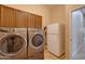 Bright laundry room, washer, dryer, and refrigerator at 21556 S 215Th Pl, Queen Creek, AZ 85142