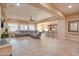 Open concept living room with kitchen view and large sectional sofa at 21556 S 215Th Pl, Queen Creek, AZ 85142