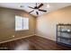 Simple bedroom with dark wood floors and ceiling fan at 24710 N 27Th Pl, Phoenix, AZ 85024